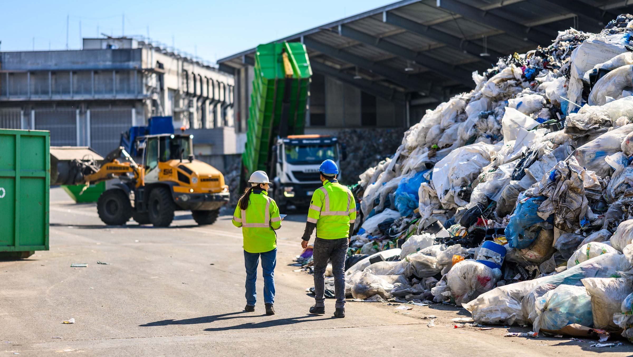 Waste management team walking through a recycling facility