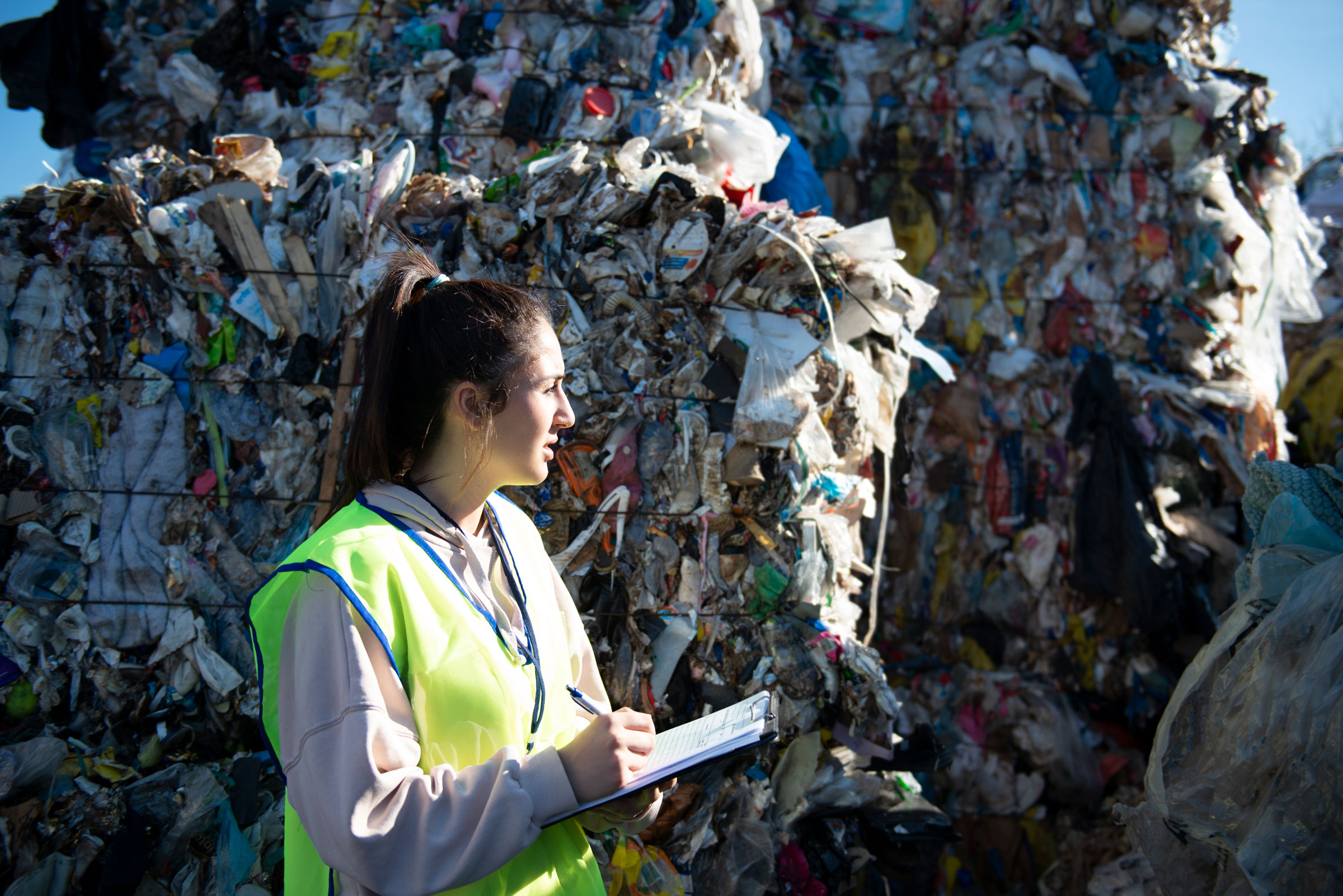 Waste audit specialist reviewing materials at a facility